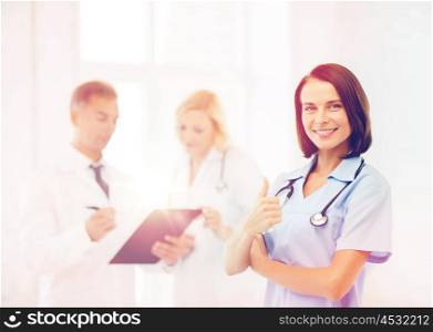 healthcare and medical concept - young female doctor with stethoscope. young female doctor with stethoscope