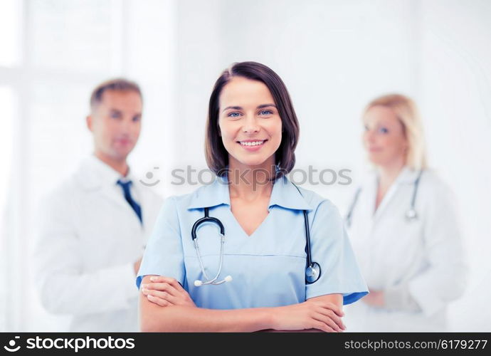 healthcare and medical concept - young female doctor with stethoscope. young female doctor with stethoscope