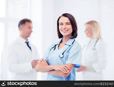 healthcare and medical concept - young female doctor with stethoscope. young female doctor with stethoscope