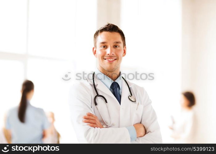 healthcare and medical concept - young male doctor with stethoscope