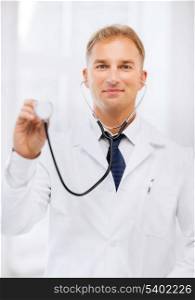 healthcare and medical concept - young male doctor with stethoscope