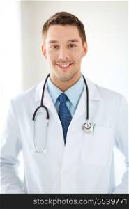 healthcare and medical concept - young male doctor with stethoscope in hospital