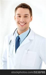 healthcare and medical concept - young male doctor with stethoscope in hospital