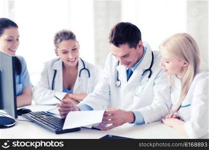 healthcare and medical concept - young team or group of doctors on meeting. young team or group of doctors on meeting