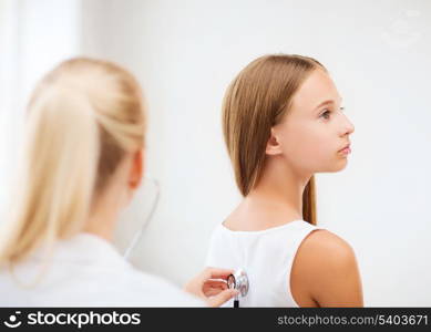 healthcare and medical - doctor with stethoscope listening to child back in hospital