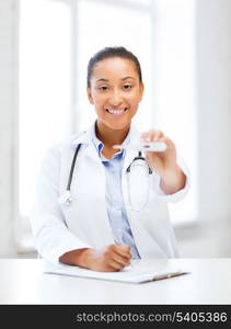 healthcare and medical - female doctor with thermometer and stethoscope