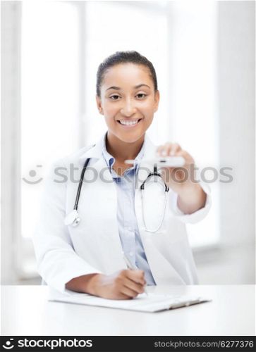 healthcare and medical - female doctor with thermometer and stethoscope