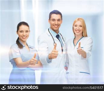 healthcare and medical - professional young team or group of doctors showing thumbs up