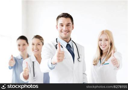 healthcare and medical - professional young team or group of doctors showing thumbs up
