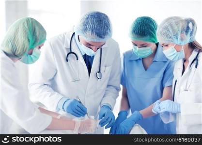 healthcare and medical - young group of doctors doing operation. young group of doctors doing operation
