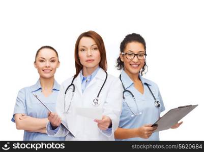 healthcare and medicine concept - calm female doctor adn nurses with clipboard and stethoscope giving prescription