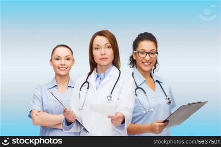 healthcare and medicine concept - calm female doctor and nurses with clipboard and stethoscope giving prescription