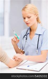 healthcare and medicine concept - calm female doctor or nurse doing injection to patient