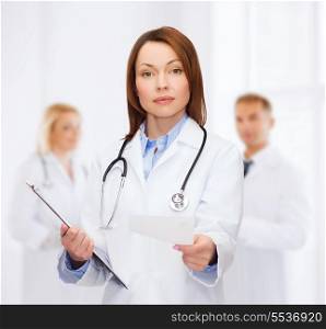 healthcare and medicine concept - calm female doctor with clipboard and stethoscope