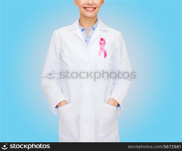 healthcare and medicine concept - close up of smiling female doctor with pink cancer awareness ribbon over blue background