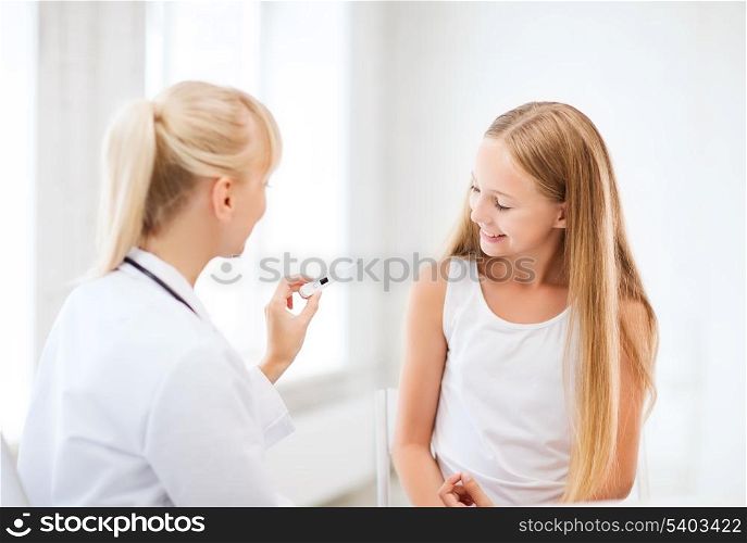 healthcare and medicine concept - doctor with child measuring temperature in hospital