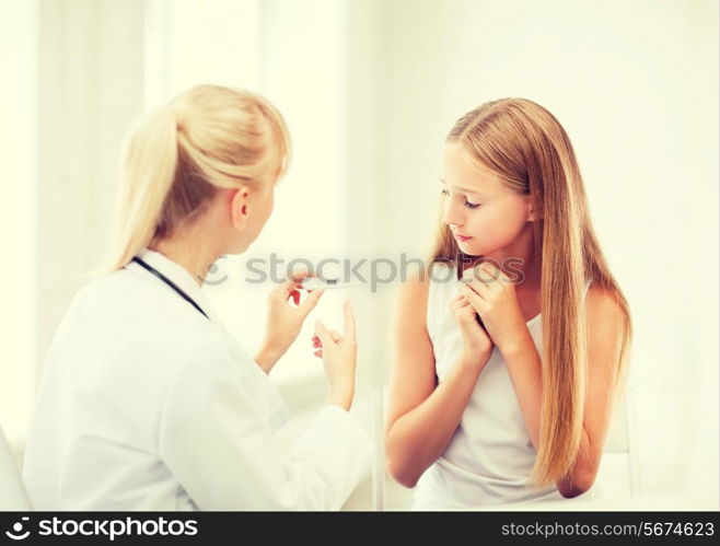 healthcare and medicine concept - doctor with child measuring temperature in hospital