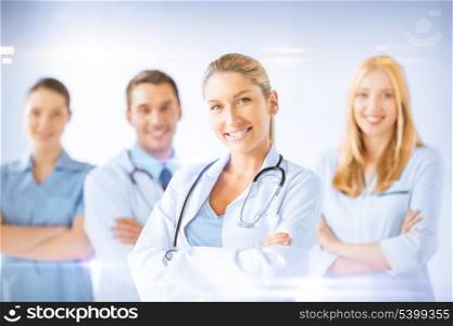 healthcare and medicine concept - female doctor in front of medical group