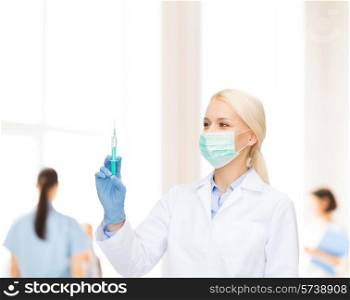 healthcare and medicine concept - female doctor in mask and gloves holding syringe with injection over blue background