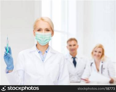 healthcare and medicine concept - female doctor in mask holding syringe with injection
