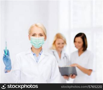 healthcare and medicine concept - female doctor in mask holding syringe with injection