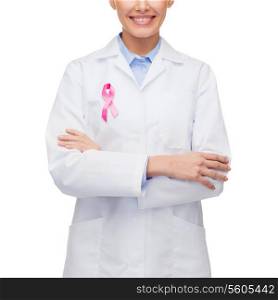 healthcare and medicine concept - female doctor with pink breast cancer awareness ribbon