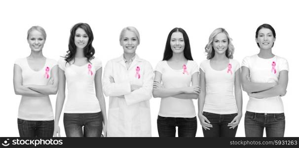 healthcare and medicine concept - group of smiling women and doctor in blank t-shirts with pink breast cancer awareness ribbons. smiling women with pink cancer awareness ribbons