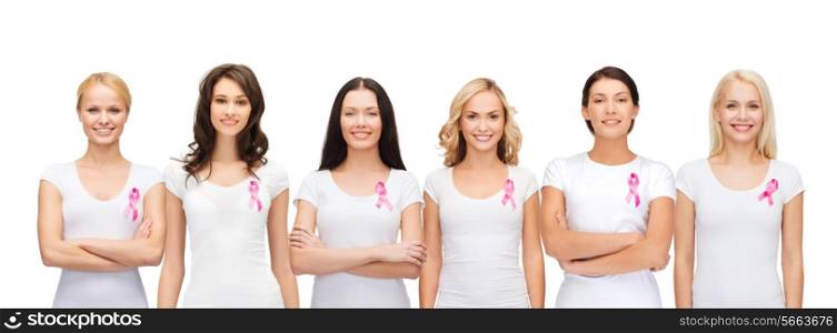 healthcare and medicine concept - group of smiling women in blank t-shirts with pink breast cancer awareness ribbons