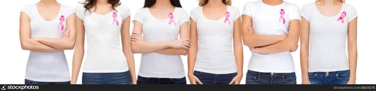 healthcare and medicine concept - group of smiling women in blank t-shirts with pink breast cancer awareness ribbons. smiling women with pink cancer awareness ribbons