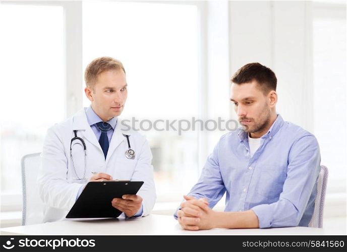 healthcare and medicine concept - serious doctor with clipboard and patient in hospital