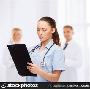 healthcare and medicine concept - serious female doctor or nurse with stethoscope and clipboard