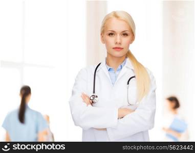healthcare and medicine concept - serious female doctor with stethoscope