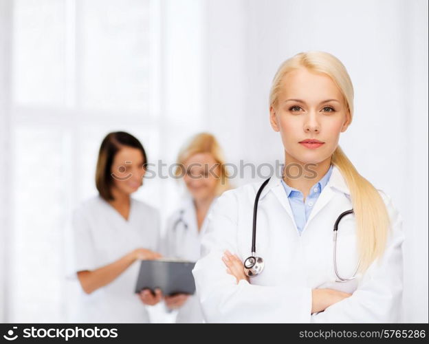 healthcare and medicine concept - serious female doctor with stethoscope