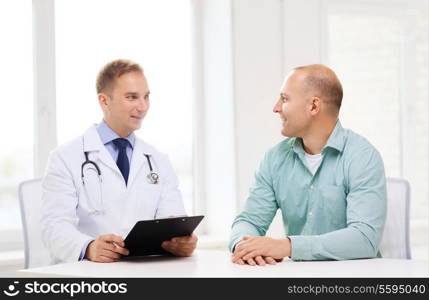 healthcare and medicine concept - smiling doctor with clipboard and patient in hospital