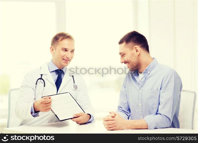 healthcare and medicine concept - smiling doctor with clipboard and patient in hospital
