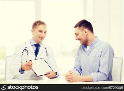 healthcare and medicine concept - smiling doctor with clipboard and patient in hospital