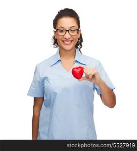 healthcare and medicine concept - smiling female african american doctor or nurse in eyeglasses with heart