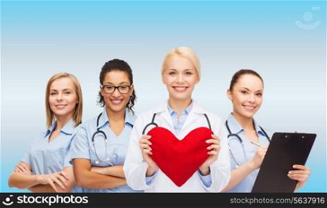 healthcare and medicine concept - smiling female doctor and nurses with red heart