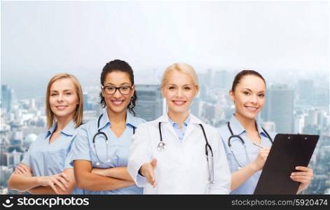 healthcare and medicine concept - smiling female doctor and nurses with stethoscope. smiling female doctor and nurses with stethoscope