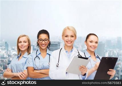healthcare and medicine concept - smiling female doctor and nurses with tablet pc