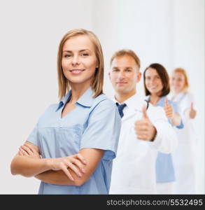 healthcare and medicine concept - smiling female doctor or nurse