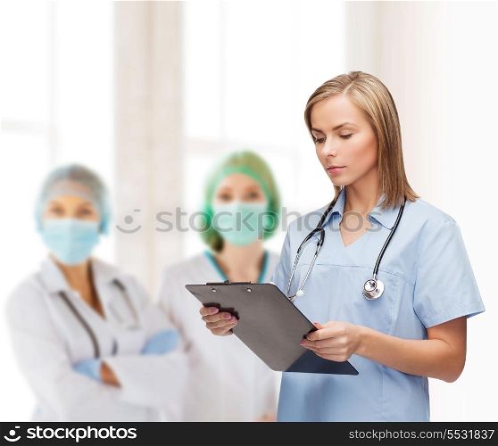 healthcare and medicine concept - smiling female doctor or nurse with clipboard and stethoscope
