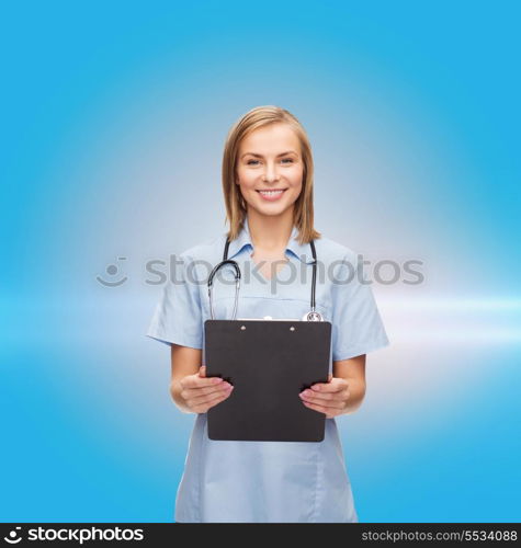 healthcare and medicine concept - smiling female doctor or nurse with clipboard and stethoscope