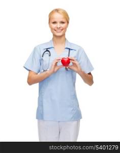 healthcare and medicine concept - smiling female doctor or nurse with heart and stethoscope