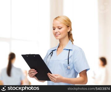 healthcare and medicine concept - smiling female doctor or nurse with stethoscope and clipboard