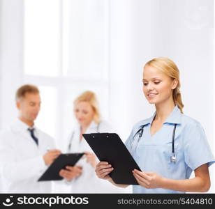 healthcare and medicine concept - smiling female doctor or nurse with stethoscope and clipboard