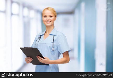 healthcare and medicine concept - smiling female doctor or nurse with stethoscope and clipboard
