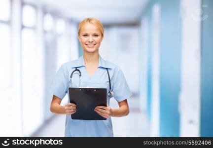 healthcare and medicine concept - smiling female doctor or nurse with stethoscope and clipboard