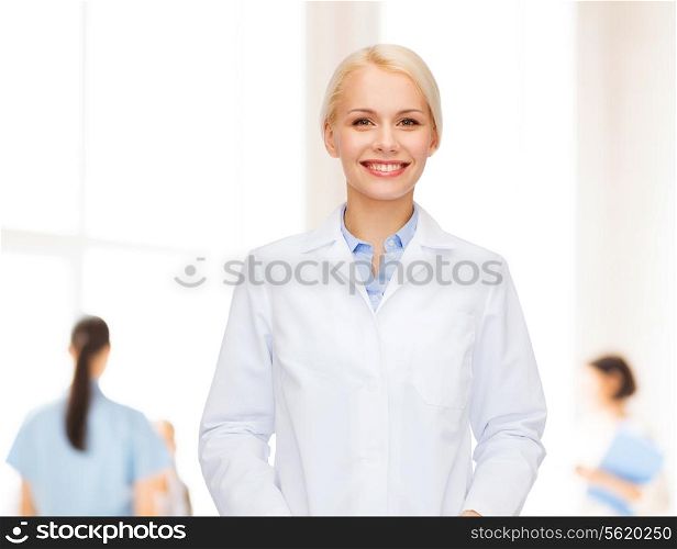 healthcare and medicine concept - smiling female doctor over group of medics in hospital