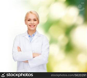 healthcare and medicine concept - smiling female doctor over natural background